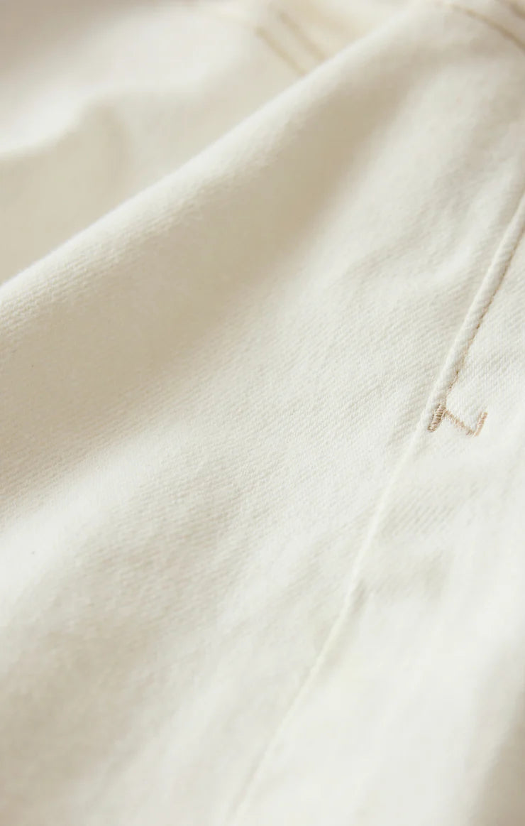 Close-up of the Cloud-colored denim fabric and pocket detailing on the Jonah Mid-Rise Short.