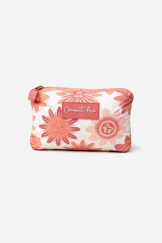 Coconut Ave Small Hele Pouch in the Lilikoʻi Blooms print made from splash-proof Tyvek® for organizing travel and everyday essentials.