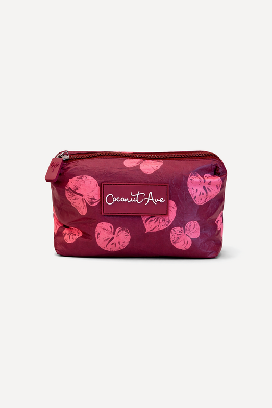 Small Hele Pouch in the Coconut Ave Na Puʻuwai print made from splash-proof Tyvek® for organizing travel and everyday essentials.
