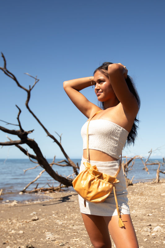 Woman wearing the Tommy Skirt in Flax paired with a matching linen top outdoors.