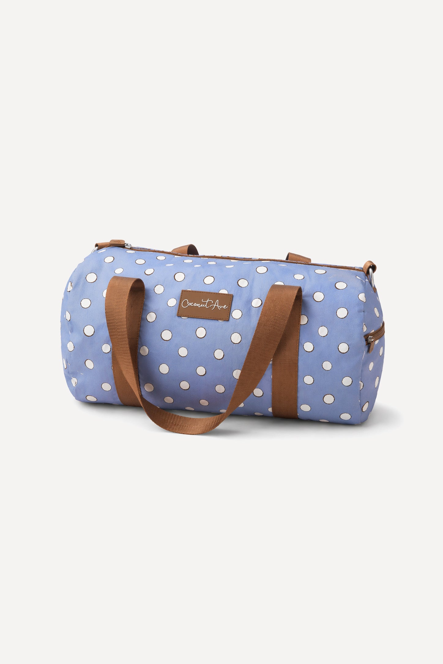 Coconut Ave Hele Duffle in the Denim Coco Dot print made from durable Tyvek® with spacious storage for travel, beach days, and everyday adventures.