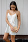 Model holding the Coconut Ave La Mer Bag styled with a white linen dress.