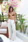 Model wearing the Coconut Ave Paloma Pant in Bamboo styled for a tropical resort look.