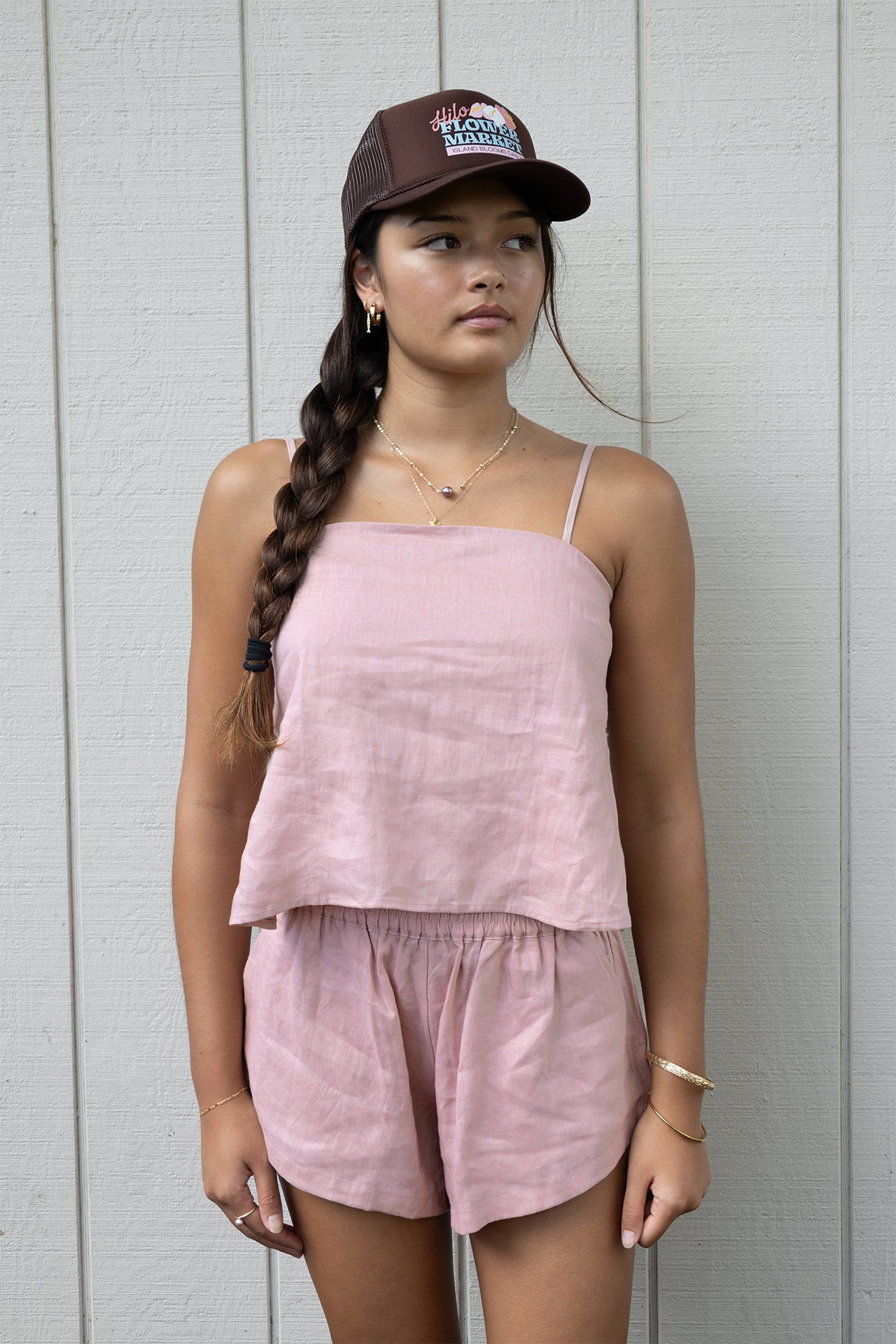 Model wearing the Coconut Ave Playa Short in Rosey paired with the matching Smocked Tube Top and trucker hat.