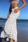 Close-up of Coconut Ave Puka Shell rayon pareo wrapped as a sarong, highlighting the tropical shell print.