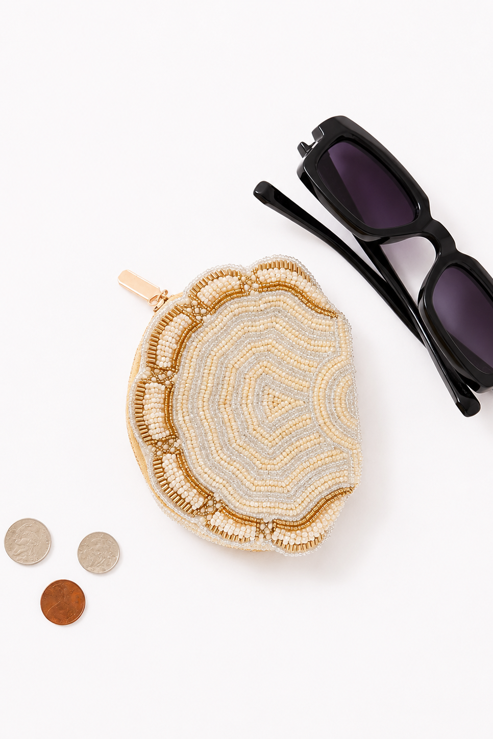 Reverse side of the Coconut Ave Shell Coin Purse displayed with sunglasses and coins, showing glass beadwork on both sides.