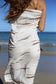 Model wearing Coconut Ave The Paddlers pareo styled as a lightweight beach wrap with an original Hawaiian-inspired print.