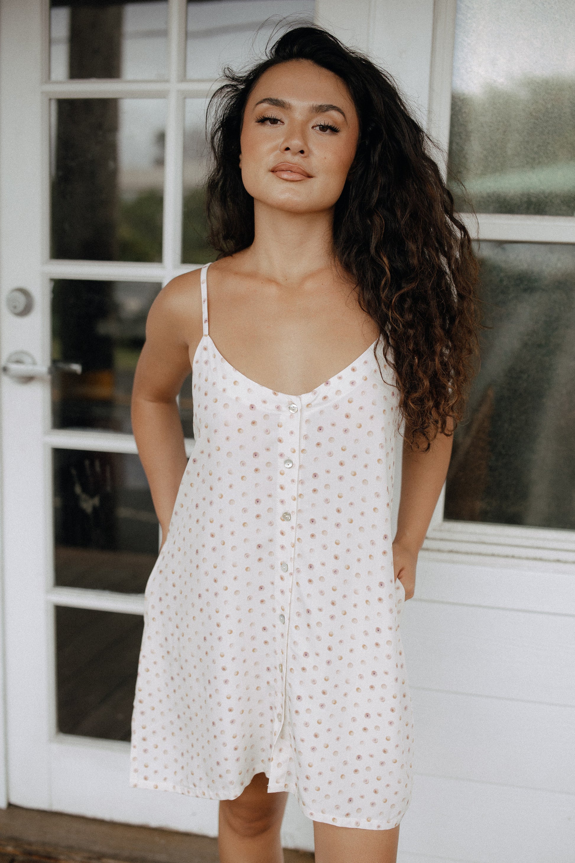 Day Tripper Dress in Puka Shell styled for an easy tropical vacation outfit at a bright outdoor entryway.