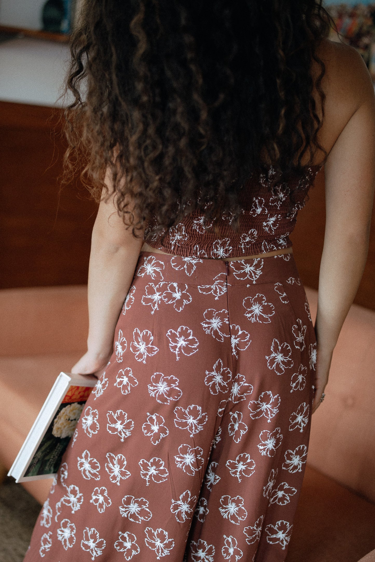 Chocolate Bloom Disco Pant styled with the matching tube top for a tropical vacation outfit, shown from the back.