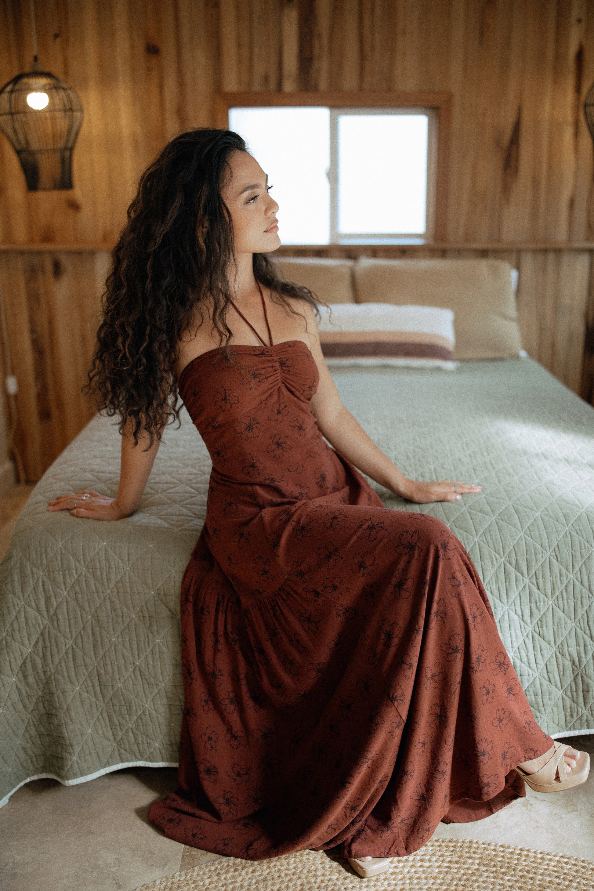 La Brisa Maxi Dress in Chocolate Bloom styled for an elegant vacation look, perfect for a sunset dinner.