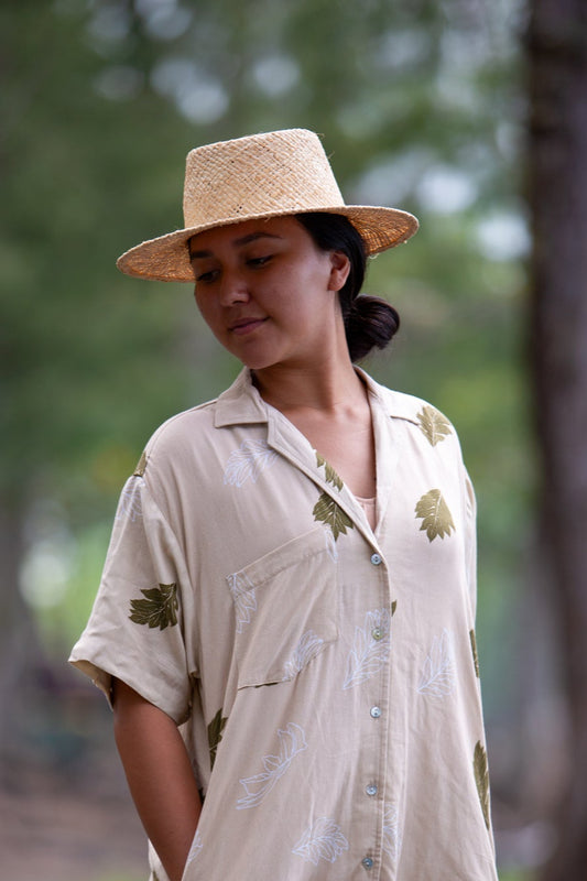 Model wearing the Coconut Ave raffia Panama hat with a relaxed resort outfit.