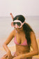 Model wearing the Coconut Ave silicone mask and snorkel set outdoors.