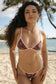 Paola Top in Chocolate Bloom worn with matching bikini bottoms on a tropical beach