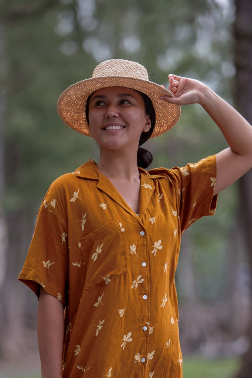 Model wearing the Coconut Ave raffia Panama hat with a tropical island-inspired look.