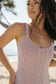 Woman wearing the Skipper One Piece Swimsuit in Bamboo Chocolate on a tropical beach