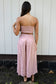 Back view of a model wearing the Coconut Ave Smocked Tube Top in Rosey with matching linen pants.