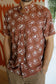 Chocolate Bloom Stay Cool Men's Shirt with tropical floral print styled for relaxed men's resort wear and warm-weather travel.