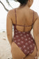 Back view of a woman wearing the Stevie One Piece Swimsuit in Chocolate Bloom on a tropical beach
