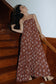 Chocolate Bloom Waikiki Maxi Dress styled with sandals for relaxed resort wear during a tropical getaway.