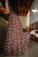 Waikiki Maxi Dress in Chocolate Bloom shown in motion as an easy vacation dress for warm-weather travel.